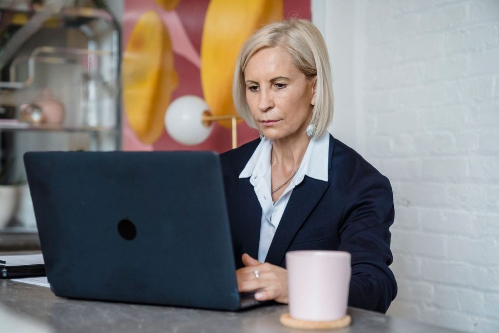 A professional woman working confidently on her laptop